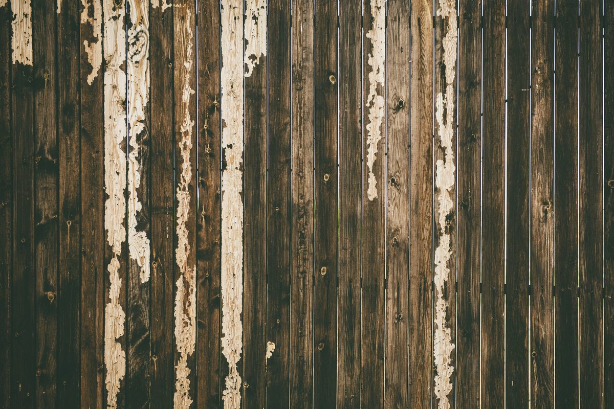 A fence with old paint peeling off