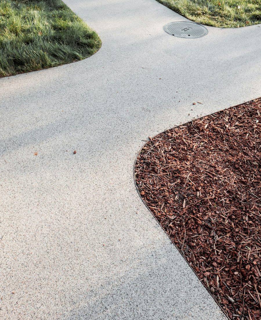 A clean walkway alongside a mulched bed